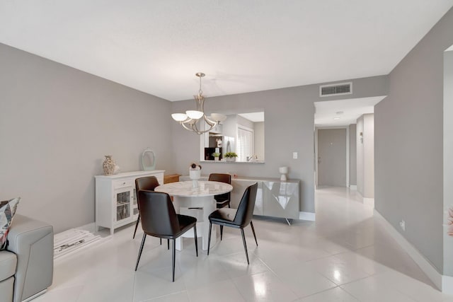 dining area with an inviting chandelier and light tile patterned floors