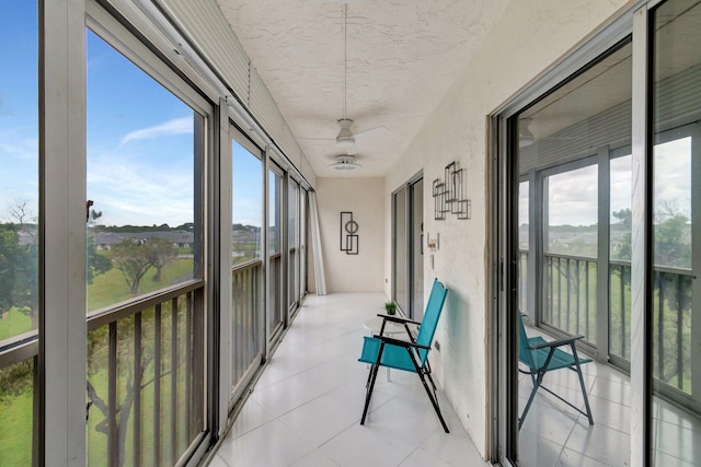 sunroom featuring a wealth of natural light and ceiling fan