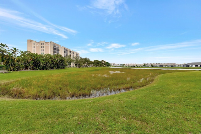 view of community with a water view and a lawn