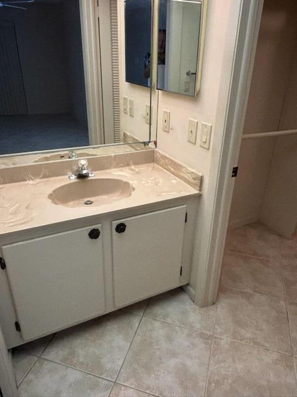 bathroom with tile patterned flooring and vanity