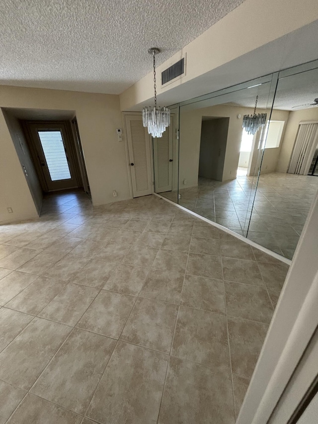 unfurnished dining area with tile patterned floors and an inviting chandelier