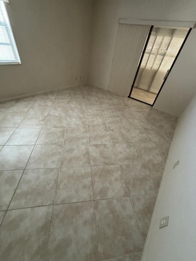 empty room with light tile patterned floors