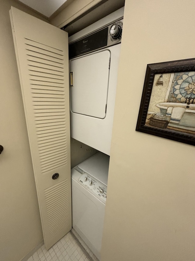 clothes washing area featuring stacked washer and dryer