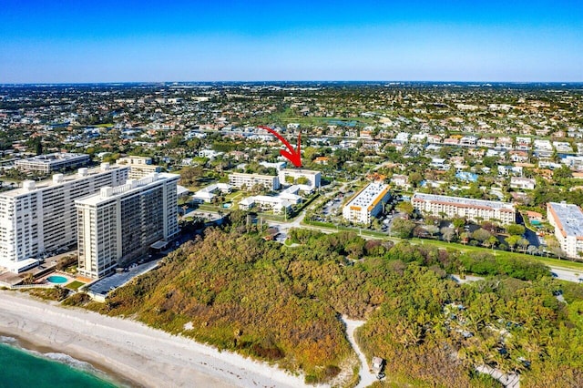 birds eye view of property with a view of the beach and a water view