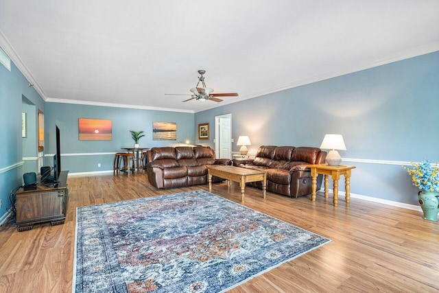 living room featuring light hardwood / wood-style floors, crown molding, and ceiling fan