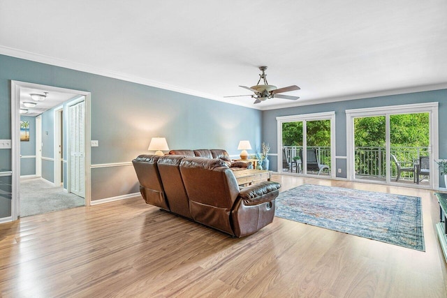 living room with ornamental molding and light wood-type flooring