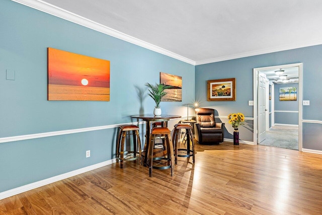 interior space with hardwood / wood-style flooring and ornamental molding