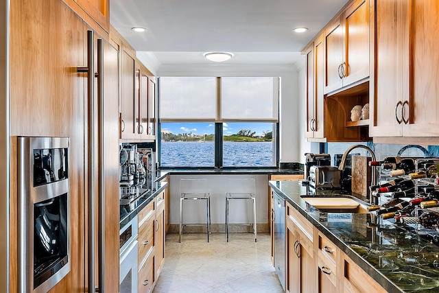 kitchen featuring sink, appliances with stainless steel finishes, and light tile patterned flooring