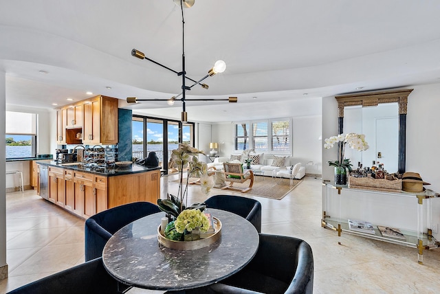 dining room featuring a chandelier and light tile patterned floors