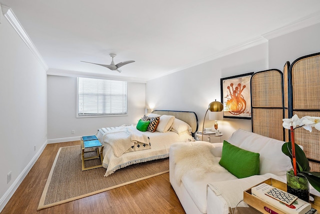 bedroom with crown molding, hardwood / wood-style flooring, and ceiling fan