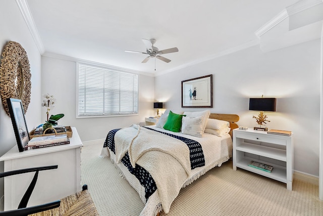 carpeted bedroom with ceiling fan and ornamental molding