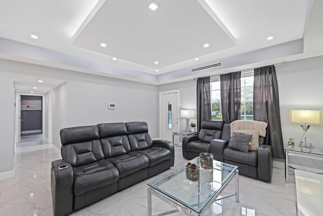 living room featuring a raised ceiling