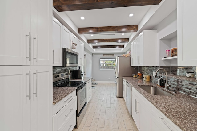 kitchen with white cabinets, dark stone countertops, sink, and appliances with stainless steel finishes