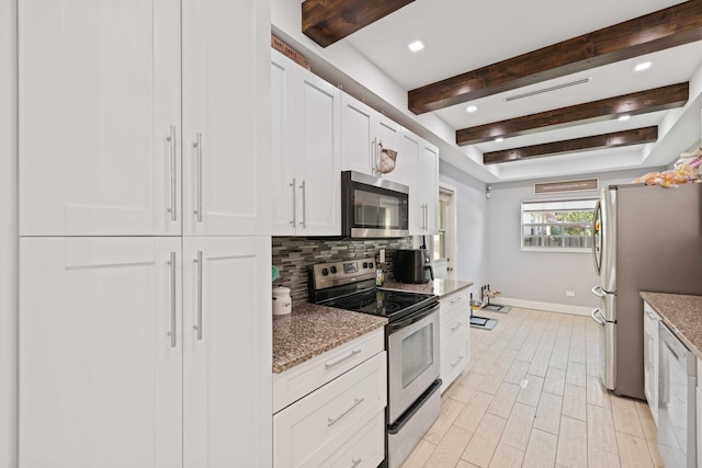 kitchen with backsplash, white cabinets, light hardwood / wood-style flooring, light stone counters, and stainless steel appliances