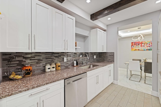 kitchen with white cabinets, sink, stainless steel dishwasher, dark stone countertops, and beam ceiling