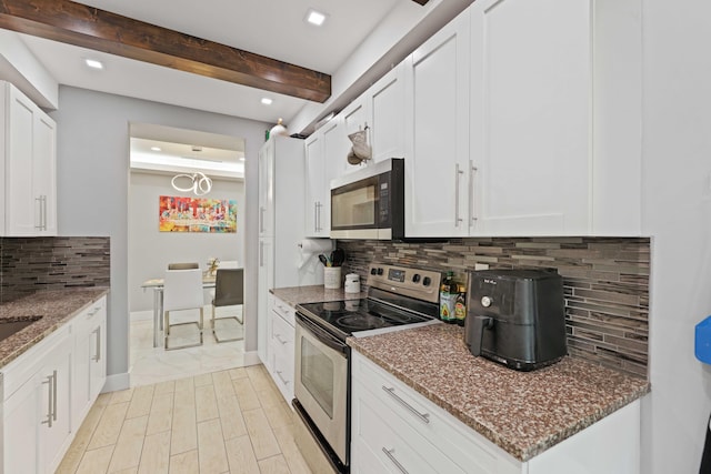 kitchen featuring beam ceiling, white cabinetry, tasteful backsplash, dark stone countertops, and appliances with stainless steel finishes