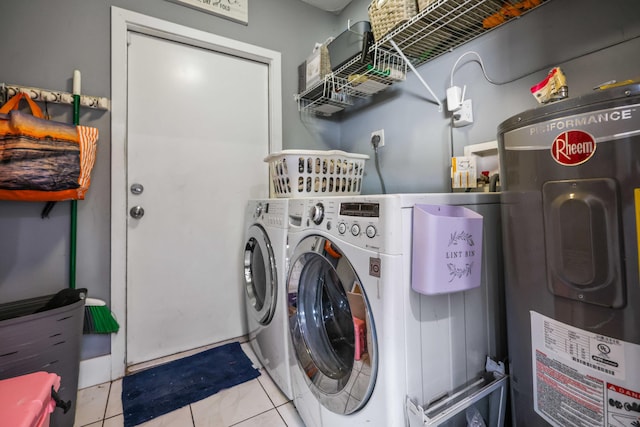 laundry room with washing machine and clothes dryer, electric water heater, and light tile patterned floors