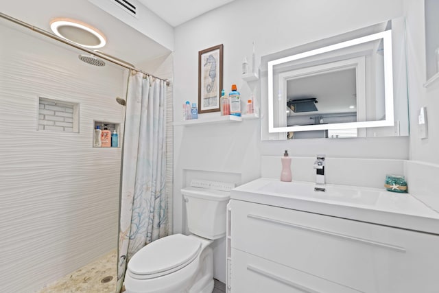 bathroom featuring vanity, curtained shower, and toilet