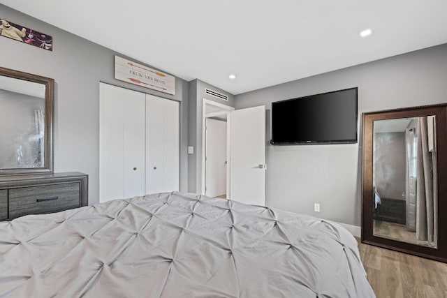 bedroom featuring a closet and light hardwood / wood-style flooring