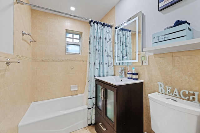 full bathroom featuring vanity, shower / bath combo with shower curtain, tile walls, tile patterned flooring, and toilet