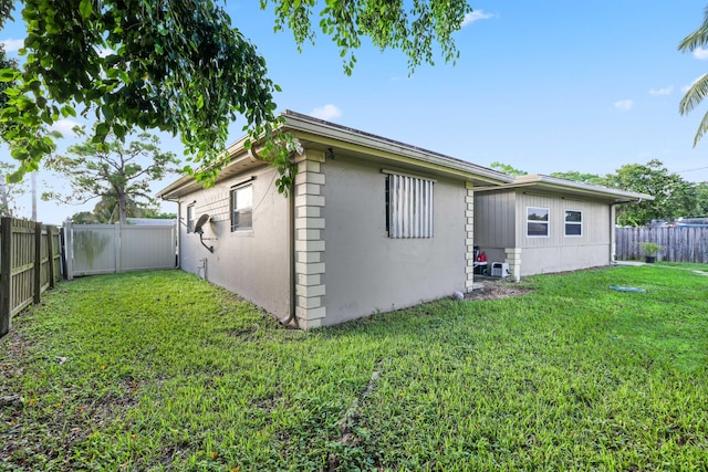 rear view of house with a yard