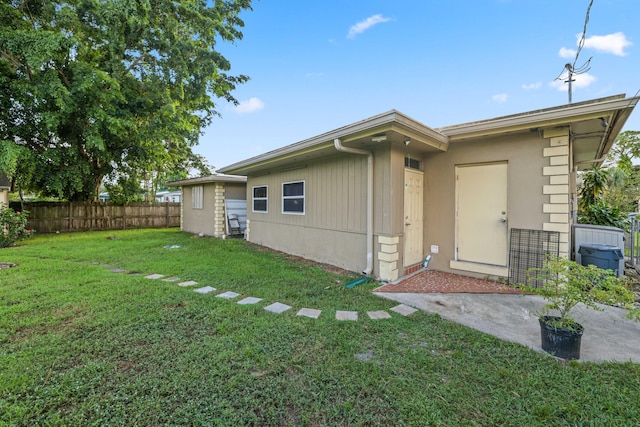 back of property featuring a yard