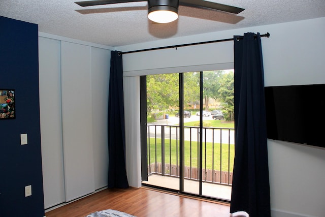 spare room with ceiling fan, a textured ceiling, and light hardwood / wood-style flooring