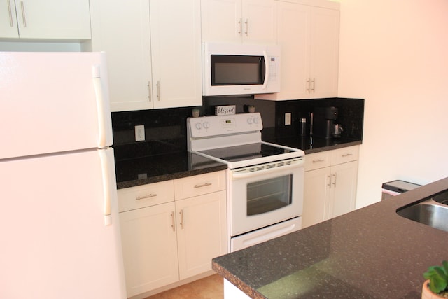 kitchen featuring white cabinetry, white appliances, and tasteful backsplash