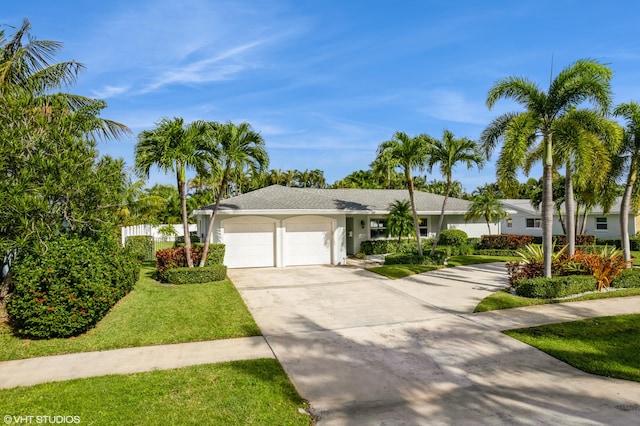 ranch-style home with a garage and a front lawn