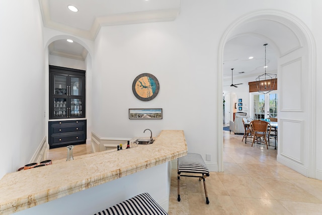 bar featuring sink, crown molding, tile patterned flooring, decorative light fixtures, and a chandelier