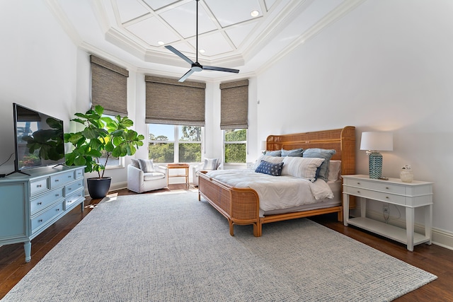 bedroom with dark wood-type flooring, ceiling fan, and ornamental molding