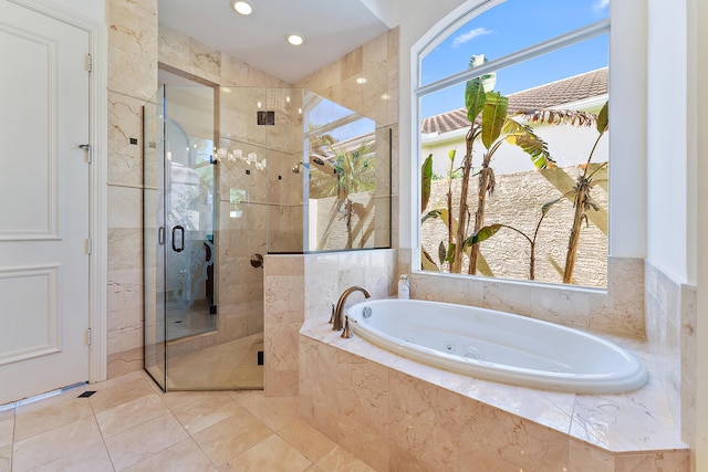 bathroom featuring tile patterned flooring and shower with separate bathtub