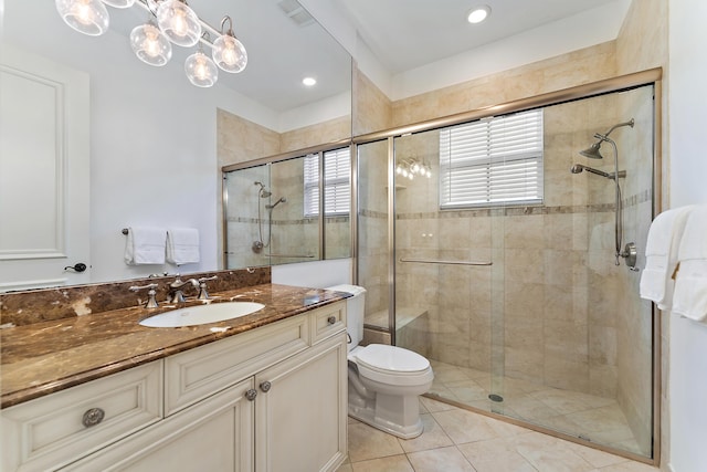 bathroom featuring tile patterned floors, vanity, toilet, and a shower with shower door