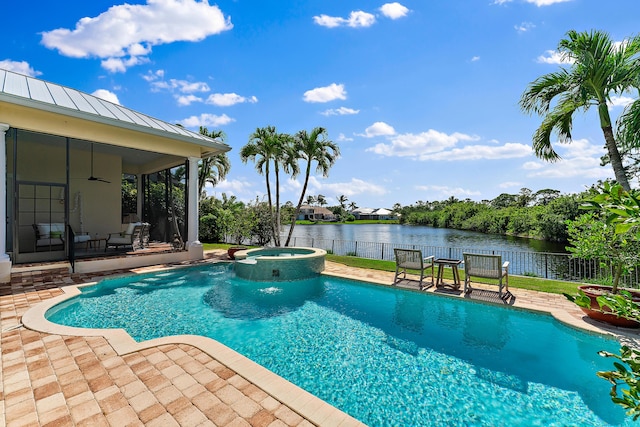 view of swimming pool featuring a water view, ceiling fan, an in ground hot tub, and a patio