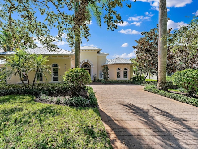 mediterranean / spanish-style house with a front lawn