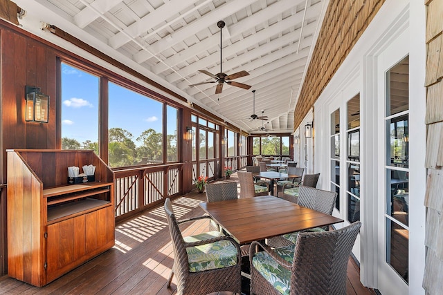 sunroom / solarium with vaulted ceiling with beams, wood ceiling, a healthy amount of sunlight, and ceiling fan