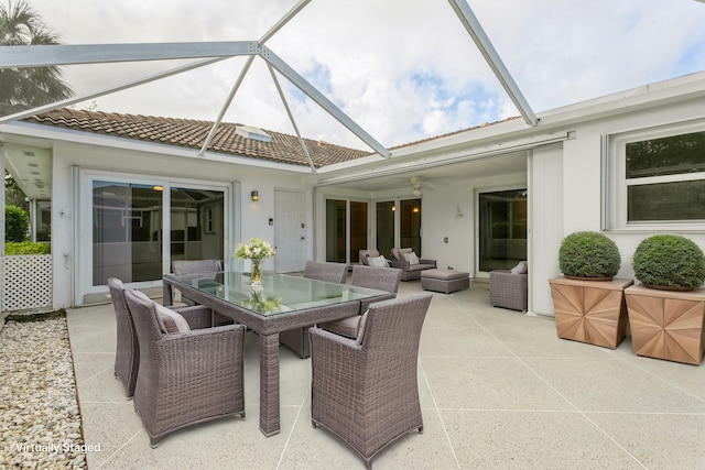 view of patio / terrace featuring ceiling fan, outdoor dining space, outdoor lounge area, and a lanai