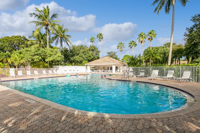 community pool featuring a patio area and fence