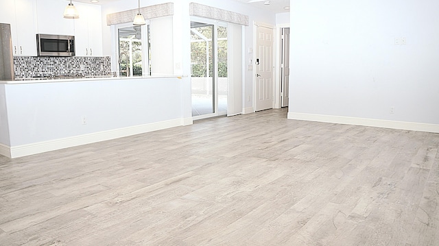 spare room featuring light hardwood / wood-style flooring and sink