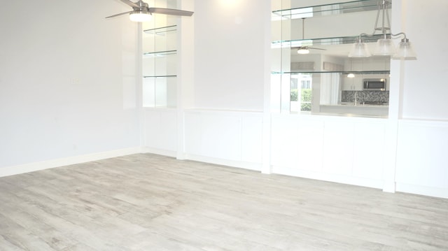 spare room with ceiling fan and light hardwood / wood-style floors