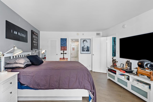 bedroom with wood-type flooring