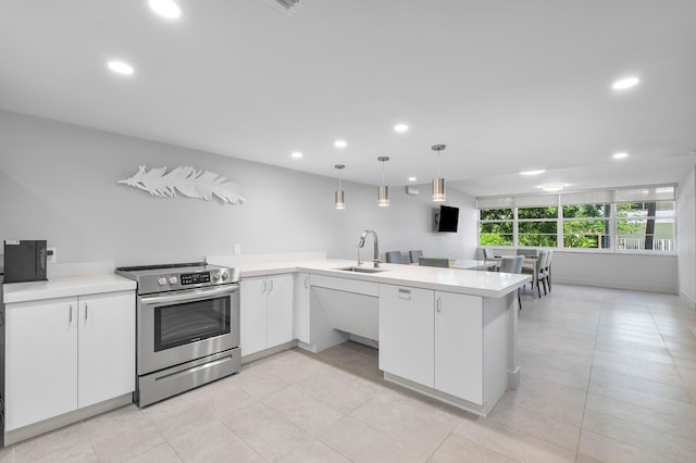 kitchen featuring kitchen peninsula, stainless steel electric stove, sink, pendant lighting, and white cabinetry