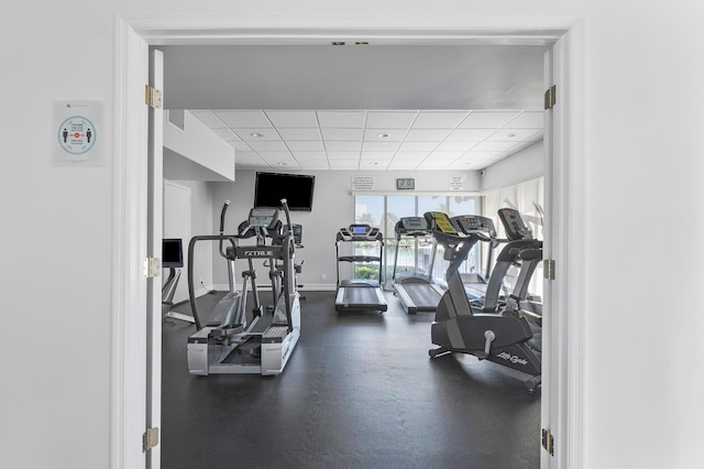 workout area featuring a drop ceiling