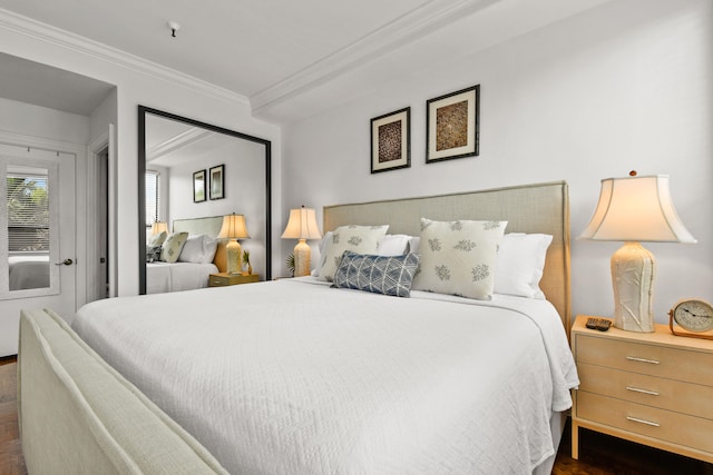 bedroom featuring dark wood-type flooring and crown molding