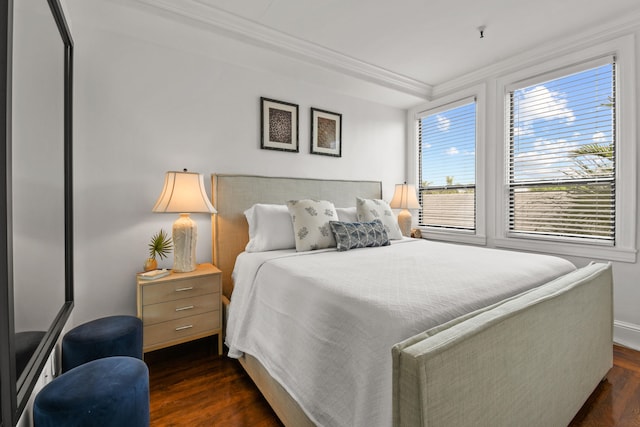 bedroom with dark hardwood / wood-style flooring, multiple windows, and ornamental molding