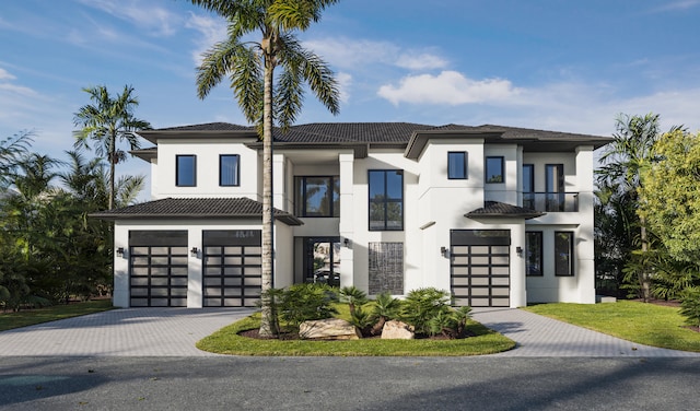 view of front of home with a balcony and a garage