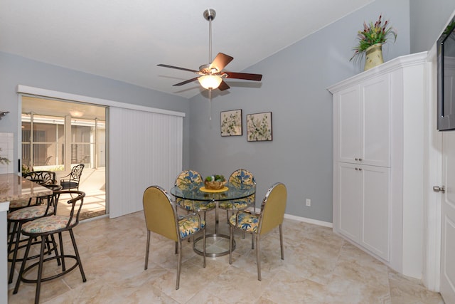 dining area featuring ceiling fan and lofted ceiling