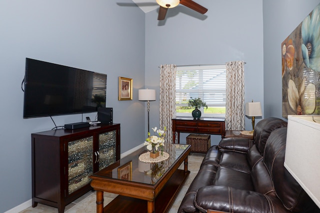 living room with ceiling fan and a high ceiling