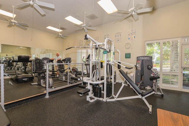 exercise room with a towering ceiling