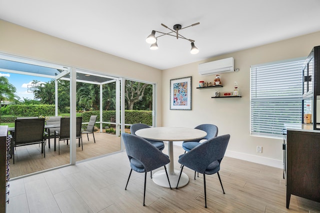 dining area featuring light hardwood / wood-style floors, a healthy amount of sunlight, a wall mounted AC, and a chandelier